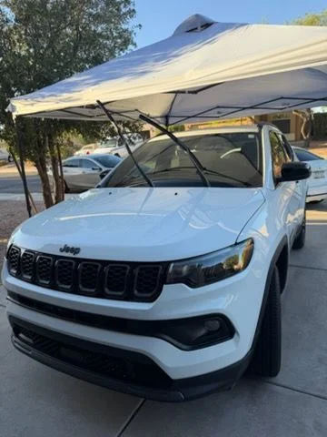 White SUV front under a driveway canopy