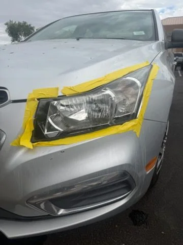 Headlight masked with tape ahead of restoration